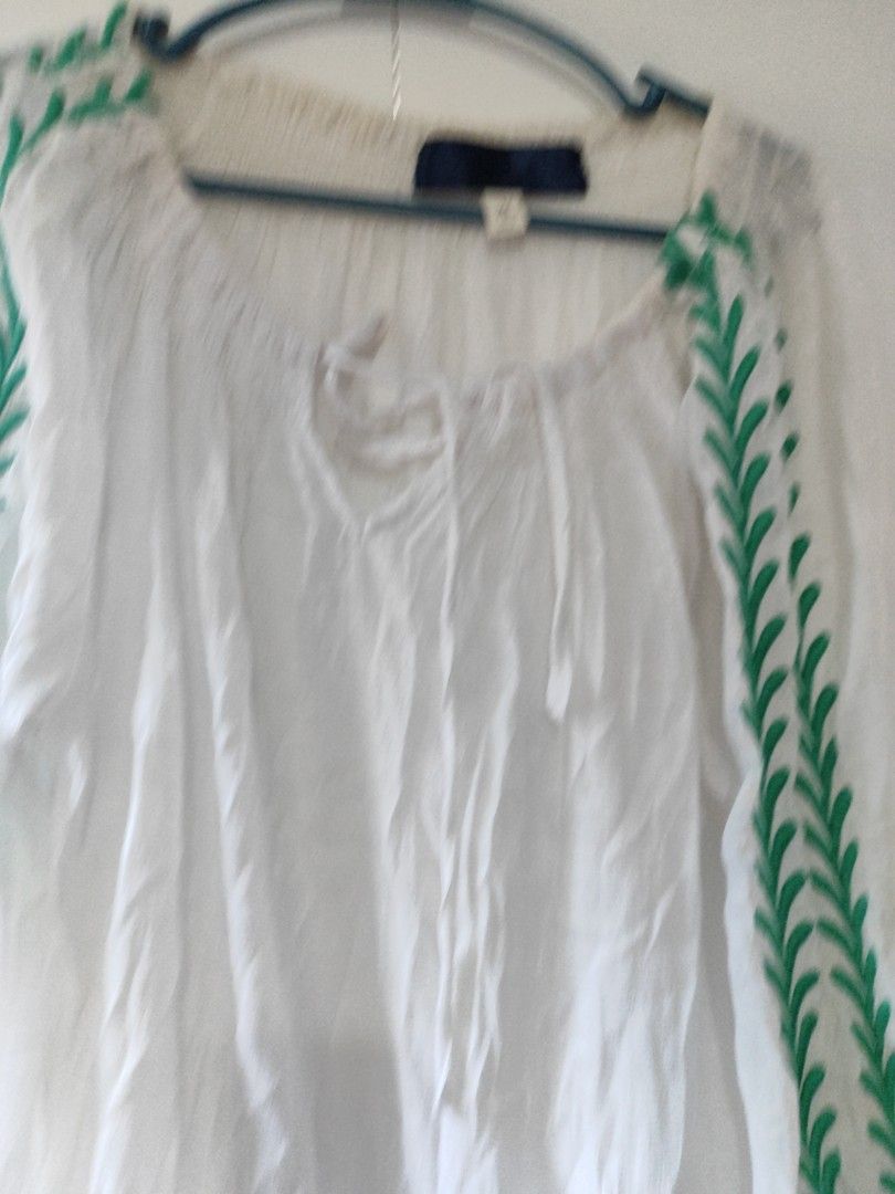 White Embroidered Blouse with Green Leaf Pattern (Category: Blouses) located in Cavite. Submitted by marosa0121 (Listing ID 1453623456, Image 3). Description: -stain on neckline - White peasant-style blouse - Green embroidered leaf pattern on sleeves and neckline - Elasticated cuffs and neckline for a - comfortable fit - Front tie detail for adjustable styling - Lightweight fabric, ideal for warm weather - Versatile piece, easy to dress up or dow