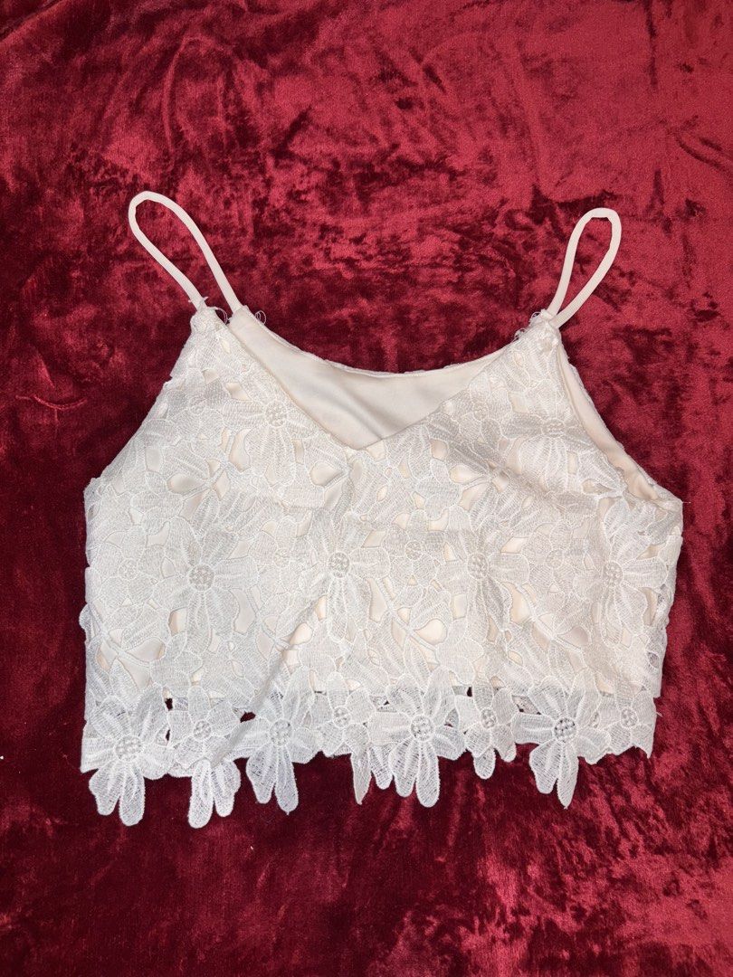 White Floral Lace Cami Crop Top (Category: Sleeveless) located in Batangas. Submitted by puccagirlypop (Listing ID 1453738050, Image 1). Description: Color: White / Off-White with nude inner lining Style: V-neck cami crop top with thin straps, floral lace overlay, and scalloped hem Fabric: Lace overlay with soft inner lining Size: Free size (Best fits Small to Medium) A delicate and romantic lace crop top! Perfect for festival looks, layering und