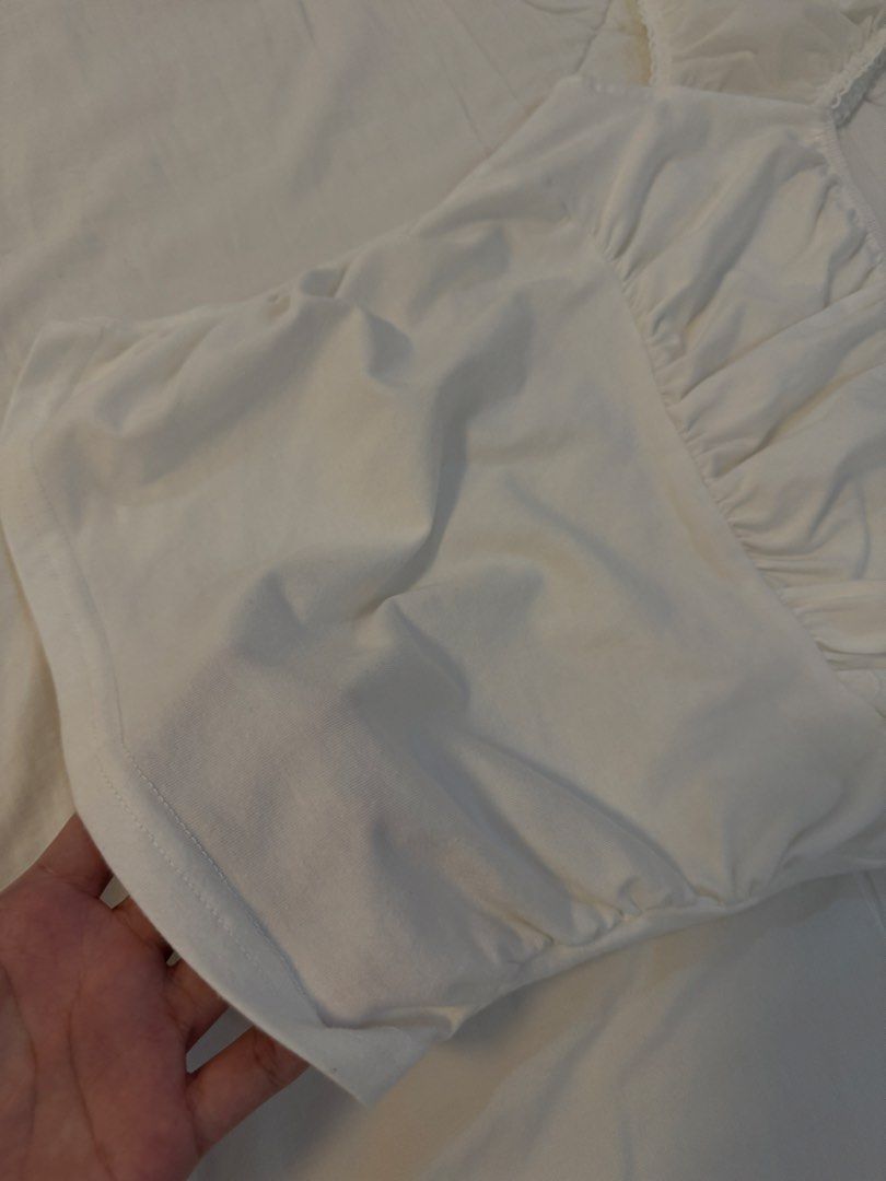 White Ruched Mesh Sleeve Top (Category: Blouses) located in Butuan. Submitted by notcwp (Listing ID 1453763146, Image 2). Description: - Adorable white top - Features delicate ruched detailing - Sheer mesh sleeves with a charming ruffled hem - Versatile: pairs perfectly with jeans or skirts - Comfortable and stylish for any occasion - Effortless to wear.