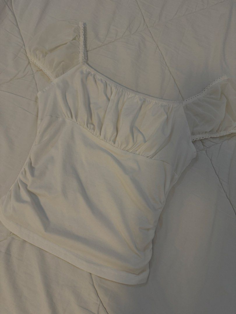 White Ruched Mesh Sleeve Top (Category: Blouses) located in Butuan. Submitted by notcwp (Listing ID 1453763146, Image 1). Description: - Adorable white top - Features delicate ruched detailing - Sheer mesh sleeves with a charming ruffled hem - Versatile: pairs perfectly with jeans or skirts - Comfortable and stylish for any occasion - Effortless to wear.