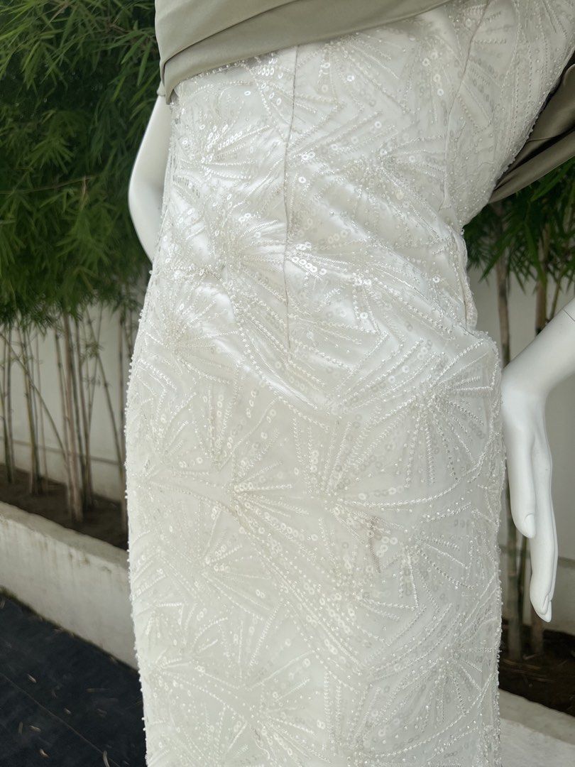 White Sequin Embellished Off-Shoulder Evening Gown (Category: Evening dresses & gowns) located in Quezon City. Submitted by amandasee21 (Listing ID 1453785258, Image 3). Description: - Elegant white floor-length gown - Intricate sequin and bead embellishments - Off-the-shoulder neckline with draped overlay - Subtle sheen fabric - Delicate lace trim at the hem - Ideal for formal events and special occasions.