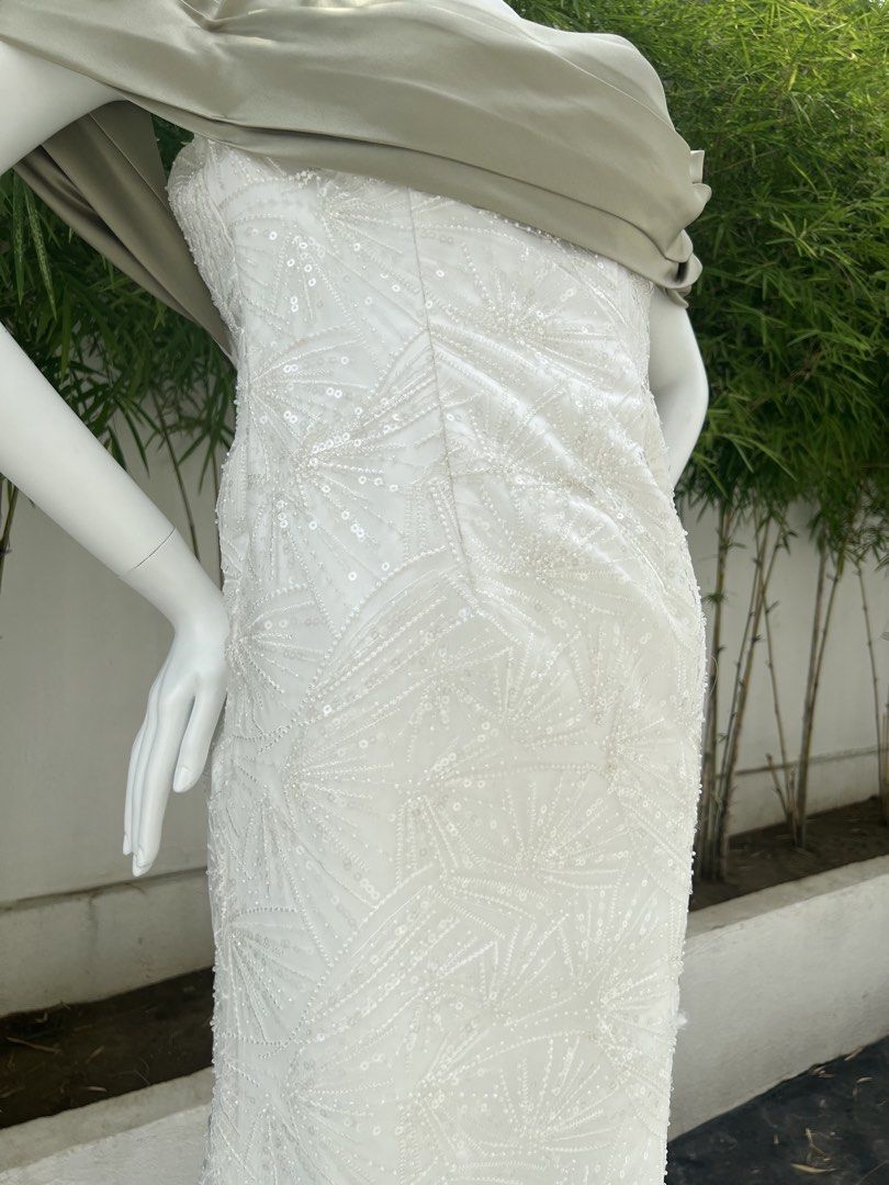 White Sequin Embellished Off-Shoulder Evening Gown (Category: Evening dresses & gowns) located in Quezon City. Submitted by amandasee21 (Listing ID 1453785258, Image 2). Description: - Elegant white floor-length gown - Intricate sequin and bead embellishments - Off-the-shoulder neckline with draped overlay - Subtle sheen fabric - Delicate lace trim at the hem - Ideal for formal events and special occasions.