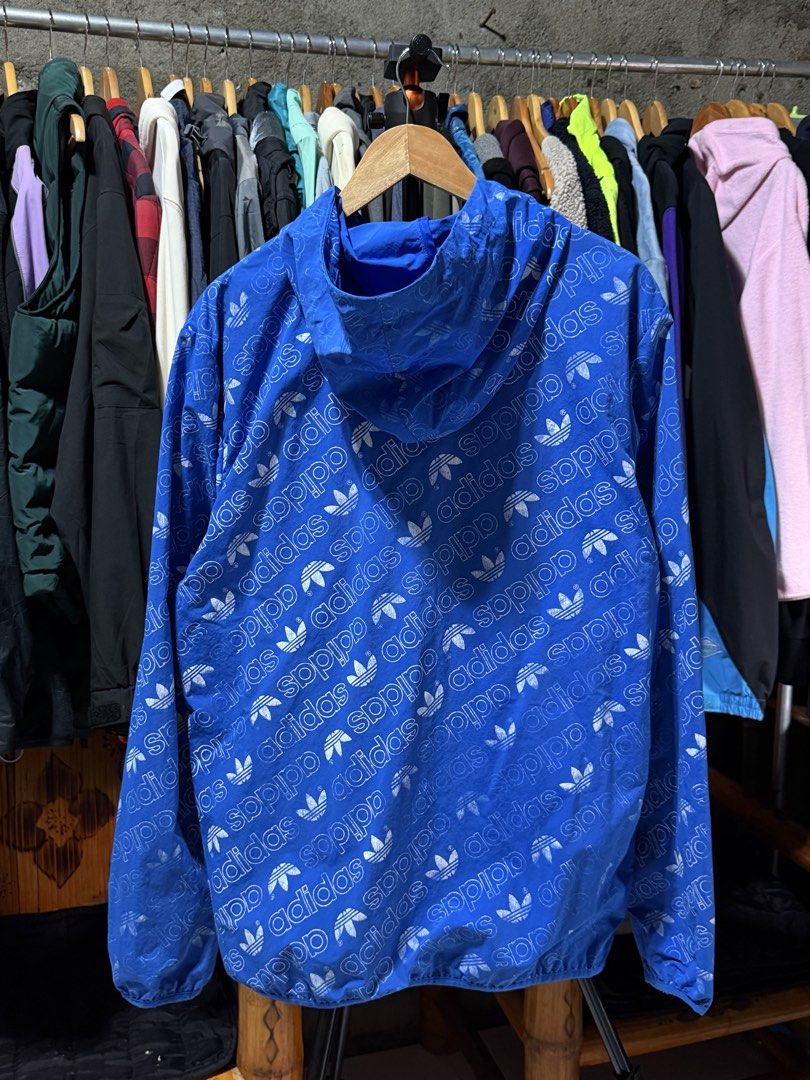Adidas All Over Print Windbreaker Jacket Blue Size M (Category: Coats, Jackets and Outerwear) located in Bulacan. Submitted by eman02 (Listing ID 1453890850, Image 2). Description: - Cool blue Adidas windbreaker - All-over trefoil logo print - Full zip front - Two zip pockets - Hooded design - Size M - Ideal for casual wear or light workouts.
