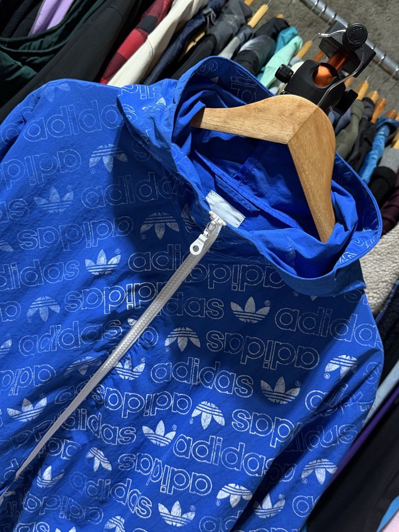 Adidas All Over Print Windbreaker Jacket Blue Size M (Category: Coats, Jackets and Outerwear) located in Bulacan. Submitted by eman02 (Listing ID 1453890850, Image 3). Description: - Cool blue Adidas windbreaker - All-over trefoil logo print - Full zip front - Two zip pockets - Hooded design - Size M - Ideal for casual wear or light workouts.