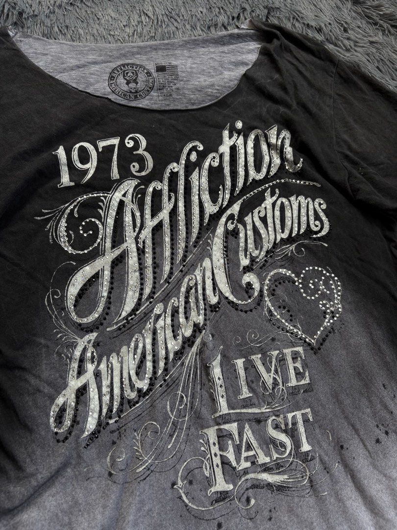 Affliction American Customs T-shirt (Category: Others Tops) located in Manila. Submitted by 3ftkl2 (Listing ID 1453855417, Image 2). Description: Size on tag: M Width: 17.50” Length: 27” Condition: Very Good Issue: Need wash / Slight yellow stain Color rate: 10/10 Note: Color may vary due to lighting. 349 + shipping none negotiable. DM us for more inquiries..