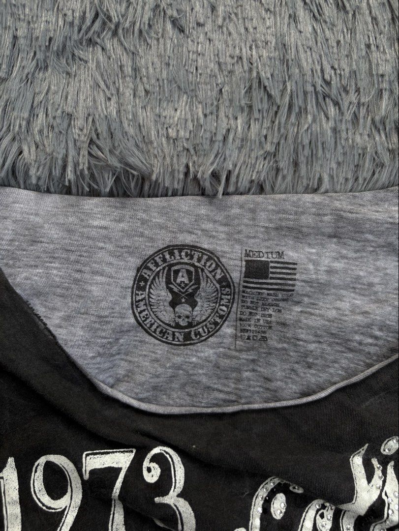 Affliction American Customs T-shirt (Category: Others Tops) located in Manila. Submitted by 3ftkl2 (Listing ID 1453855417, Image 3). Description: Size on tag: M Width: 17.50” Length: 27” Condition: Very Good Issue: Need wash / Slight yellow stain Color rate: 10/10 Note: Color may vary due to lighting. 349 + shipping none negotiable. DM us for more inquiries..