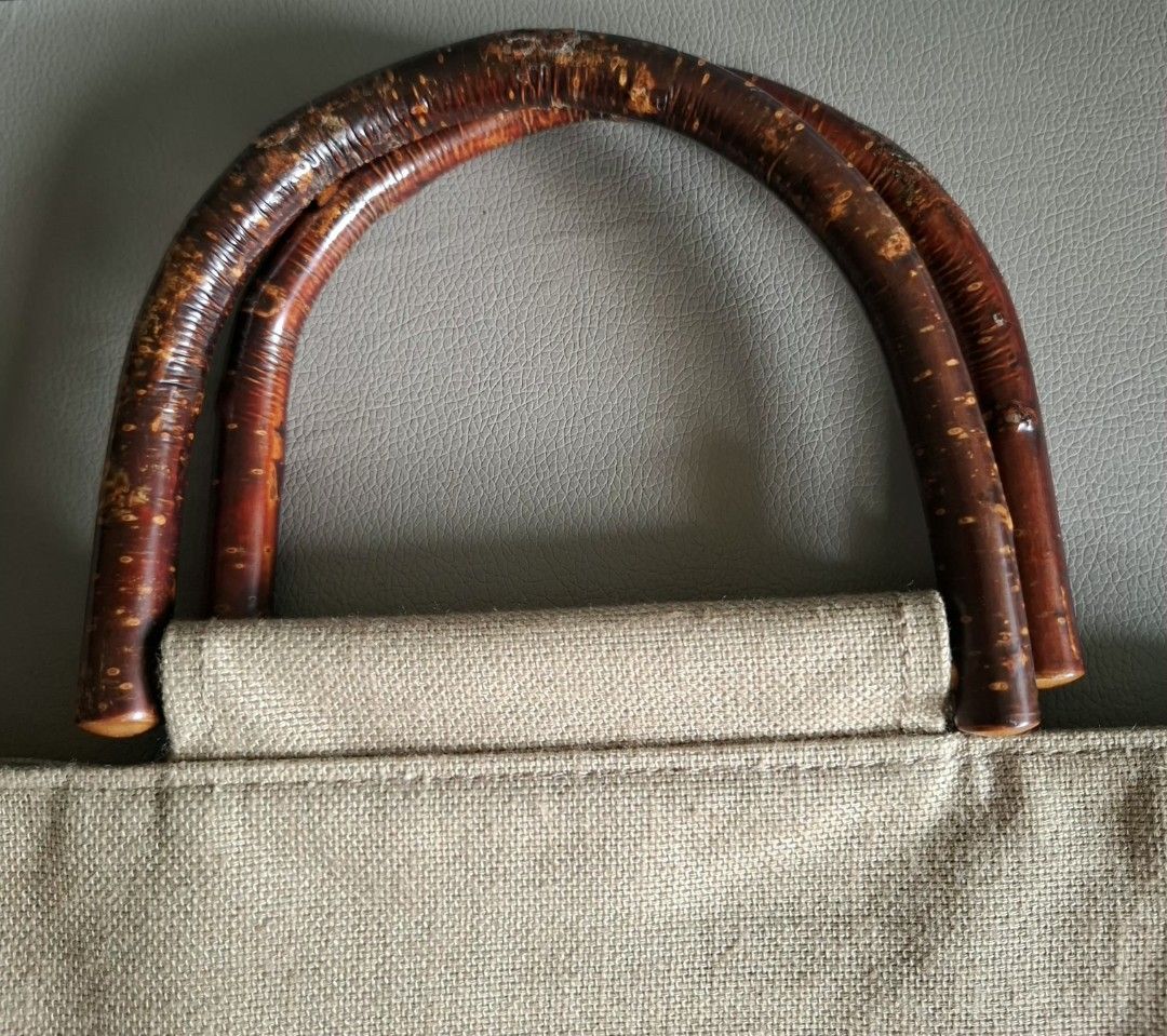 Agnes b. Canvas Tote Bag with Bamboo Handles (Category: Tote Bags) located in Don Carlos. Submitted by PphiXi_Finds (Listing ID 1453987497, Image 2). Description: - Agnes B Light beige canvas tote bag - Unique curved wooden handles - Interior slip pockets for organization - Ideal for everyday use or beach trips - Approx. 13" tall x 14" wide.