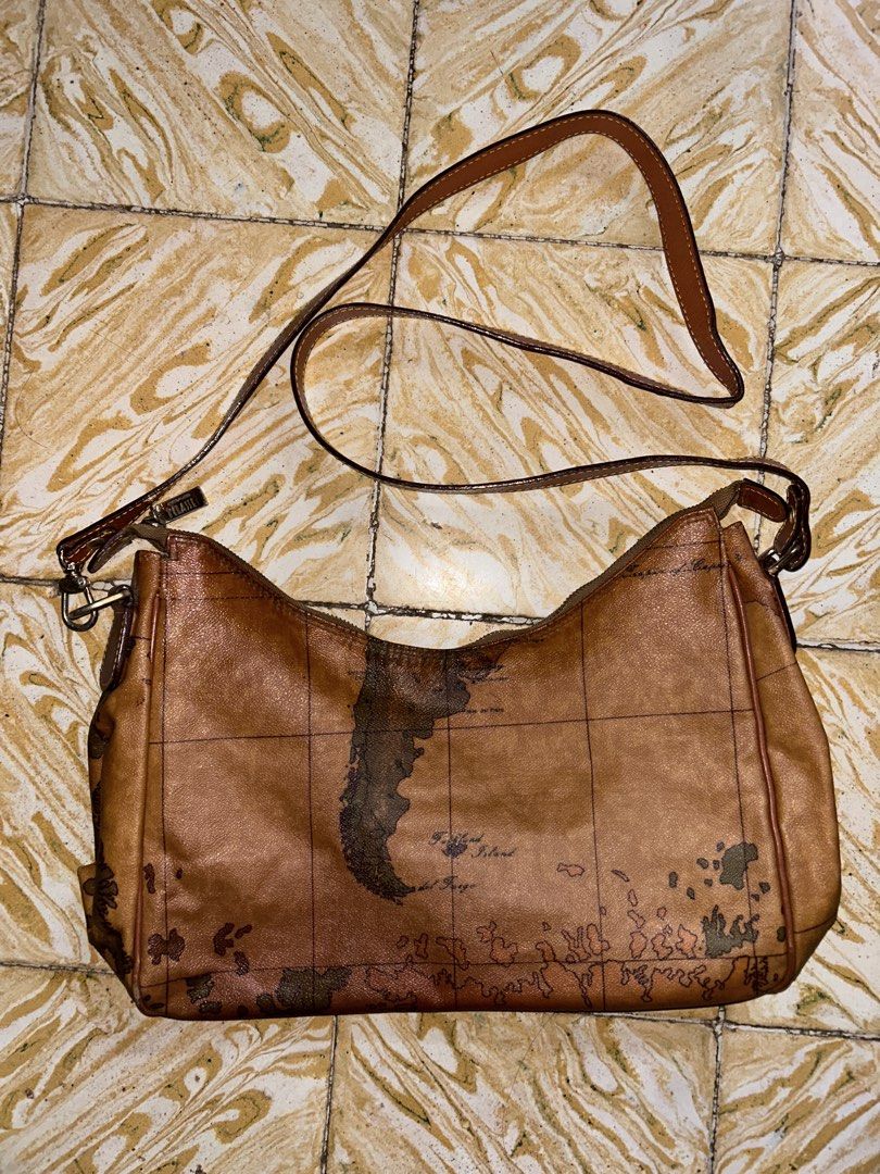 Alviero Martini 1a Classe Geo Map Shoulder Bag (Category: Luxury Bags & Wallets) located in Dipolog. Submitted by adrian281994 (Listing ID 1453865352, Image 3). Description: - Iconic Alviero Martini map print - Tan leather trim - Zipper closure - Adjustable strap - Ideal for travel or everyday use - Shows some signs of wear, but plenty of life left - Unique and eye-catching design.