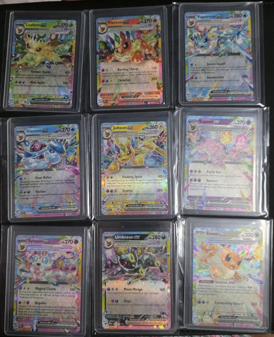 Assorted characters card (Category: Raw Cards) located in Singapore. Submitted by givena0101 (Listing ID 1453986621, Image 1). Description: Collection of nine raw Pokémon ex cards featuring various Eeveelutions and Eevee. Each card is individually protected in a clear plastic sleeve, keeping them in great shape. Perfect for any Eevee fan looking to complete their set or add some high-energy, colorful cards to their collection..