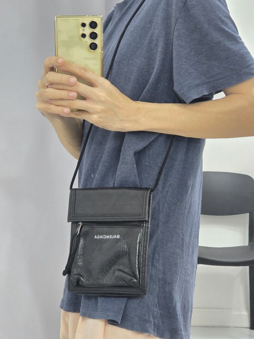 Balenciaga Black Leather Wallet with Strap (Category: Luxury Bags & Wallets) located in Las Pinas. Submitted by vanpru (Listing ID 1453996539, Image 2). Description: - Authentic Balenciaga black leather wallet - Features a secure zip pocket and convenient card slots - Comes with a versatile long strap for crossbody or neck wear - Perfect for carrying your essentials on the go.