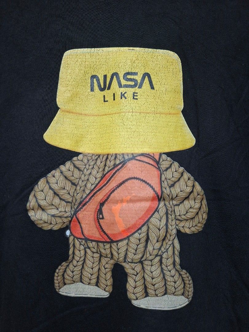 Black NASA Like Graphic T-Shirt (Category: Tshirts & Polo Shirts ) located in Batangas. Submitted by sell_ph (Listing ID 1453932248, Image 3). Description: - Black t-shirt with a cool graphic on the back. - Features a teddy bear wearing a yellow bucket hat and a fanny pack. - The bucket hat has 'NASA LIKE' printed on it. - Perfect for casual everyday wear..