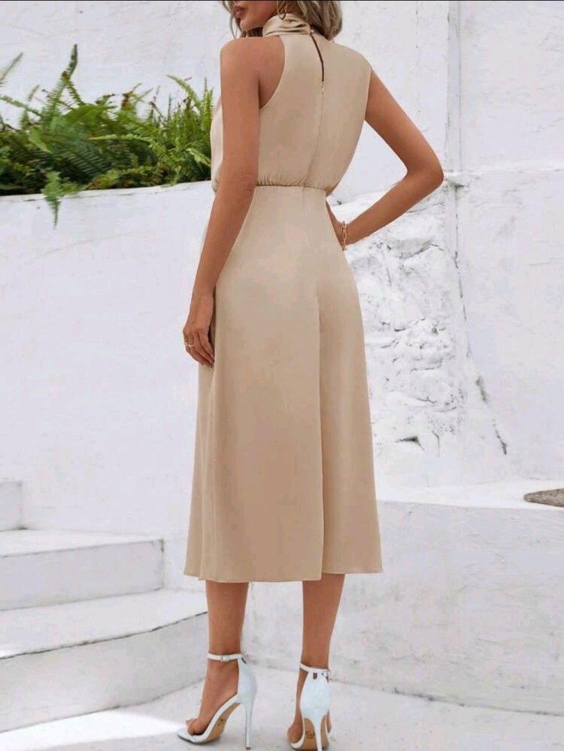 BNWT Elegant Beige Halter Neck Midi Dress (Category: Dresses) located in Quezon City. Submitted by samcas (Listing ID 1453906897, Image 2). Description: Beige sleeveless halter neck midi dress with cinched waist and flowy skirt. Back zipper. Perfect for events or evenings out..