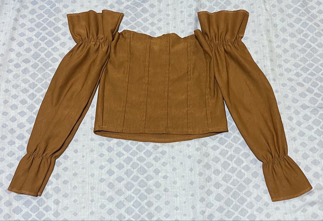 Brown Off-Shoulder Corset Top with Ruffled Sleeves (Category: Others Tops) located in La Trinidad. Submitted by epicwater_dc38bf (Listing ID 1453955877, Image 1). Description: - Trendy brown off-shoulder top - Corset style with flattering vertical seams - Long sleeves with stylish ruffles at shoulders and cuffs - Ideal for night outs or special occasions - Versatile: pair with jeans or a skirt.