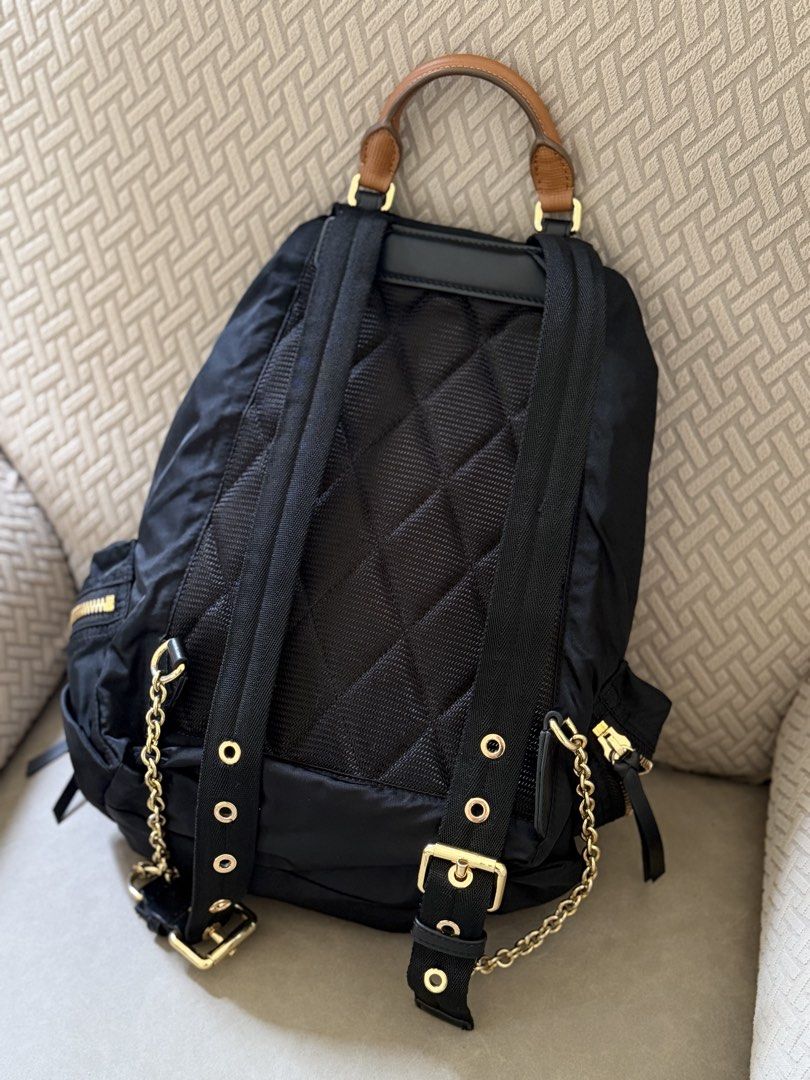 Authentic Burberry Nylon Leather Trim Backpack Gold Hardware (Category: Backpacks) located in Cebu City. Submitted by gdcebu (Listing ID 1453889625, Image 3). Description: - Burberry backpack in black nylon - Tan leather trim - Gold hardware - Adjustable straps - Drawstring closure with buckle flap - Multiple zip pockets - Ideal for everyday use or travel.