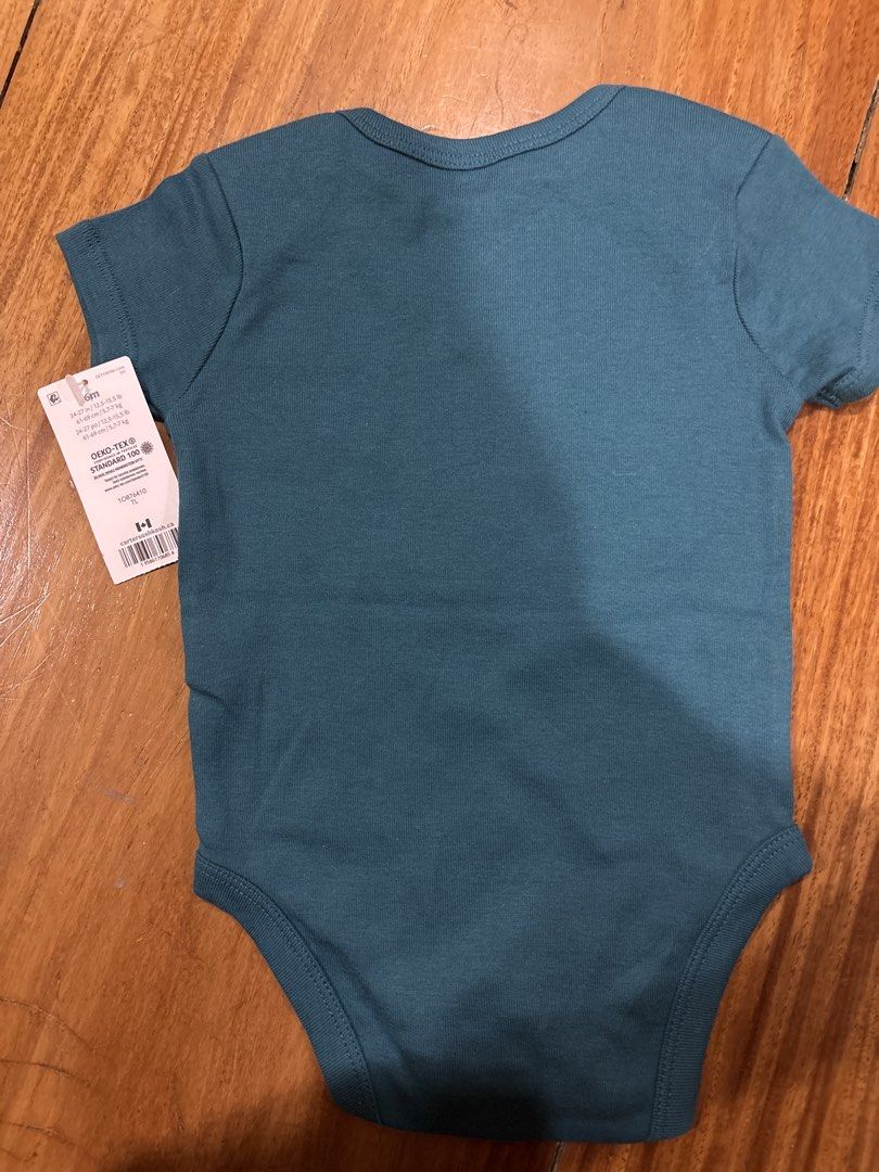 Carter's Baby Bodysuit 6M (Category: Babies & Kids Fashion) located in Pasig City. Submitted by logorini (Listing ID 1453973887, Image 2). Description: - Cute Carter's baby bodysuit - Short sleeves - Teal blue color - Features a dog graphic with "My best friend has Paws!" text - Made with OEKO-TEX certified fabric - Perfect for your little one.