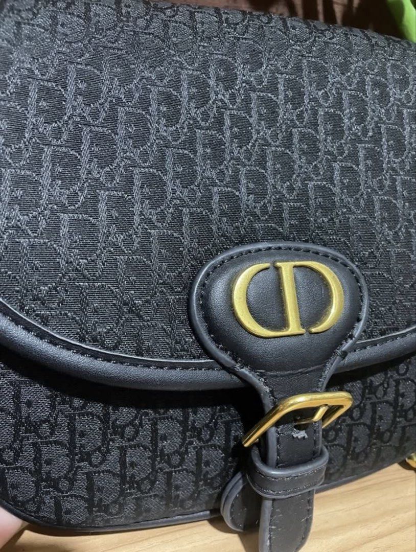 Christian Dior Black Monogram Saddle Bag (Category: Luxury Bags & Wallets) located in Alaminos. Submitted by remyraon_preloved (Listing ID 1453845262, Image 3). Description: Thrifted preloved item, with flaw at the back as seen in the photo, has minimal lippy stain in its interior. With adjustable leather strap(detachable) .