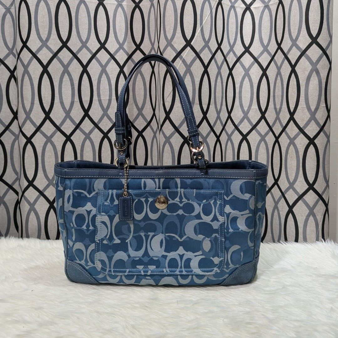 Coach Monogram Denim Tote Bag (Category: Luxury Bags & Wallets) located in Manila. Submitted by eladp (Listing ID 1453960929, Image 1). Description: - Classic Coach tote bag - Blue denim with signature C monogram pattern - Genuine leather trim and handles with suede parts - Easy-access front pocket - Silver hardware details - Perfect stylish everyday bag.