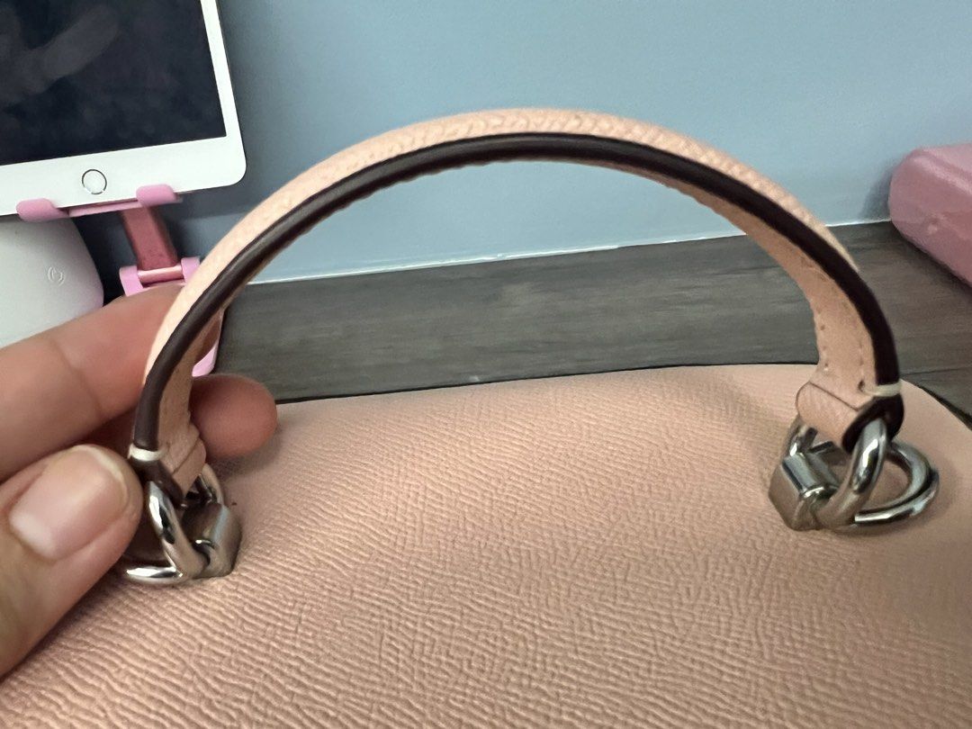 Coach Pink Leather Vanity Case Bag with Strap (Category: Luxury Bags & Wallets) located in Santa Rosa. Submitted by kendraem (Listing ID 1453915075, Image 3). Description: - Adorable pink Coach vanity case - Crafted from textured leather - Includes a convenient top handle - Comes with a detachable crossbody strap for versatile wear - Zippers feature the iconic Coach New York logo - Ideal for storing makeup or small essentials - Flat and structure