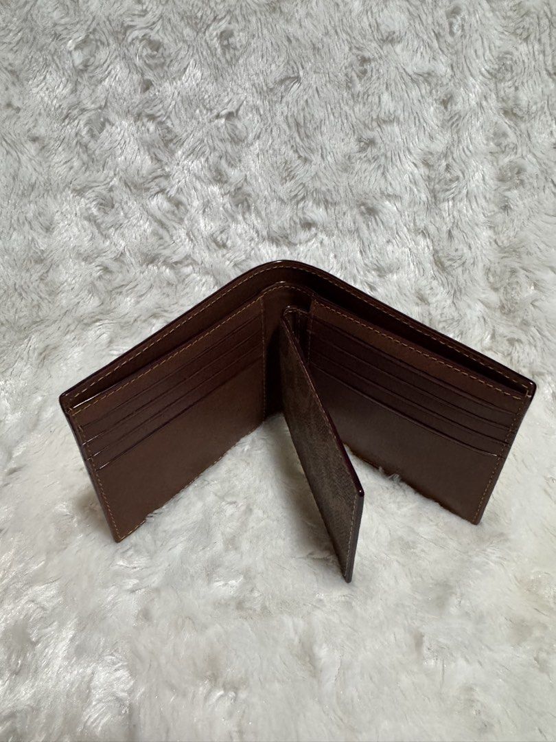 Coach Signature Bifold Wallet (Category: Luxury Bags & Wallets) located in Carmona. Submitted by outletshopper.ph (Listing ID 1453960452, Image 3). Description: - Authentic Coach bifold wallet - Signature 'C' pattern exterior - Multiple card slots inside - Clear ID window - Genuine leather lining - Classic and versatile design - Ideal for everyday use *with very minimal flaws thus selling low *shipping fee shouldered by buyer.