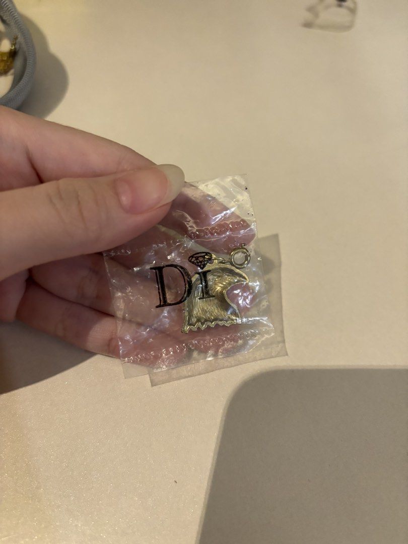 Dior Gold Eagle Head Pendant Charm (Category: Charms) located in Manila. Submitted by pepper7779 (Listing ID 1453884197, Image 2). Description: - Authentic gold eagle head charm - Comes in original packaging - Small and intricately detailed - Ideal for DIY jewelry projects - Can be used as a unique keychain accessory.