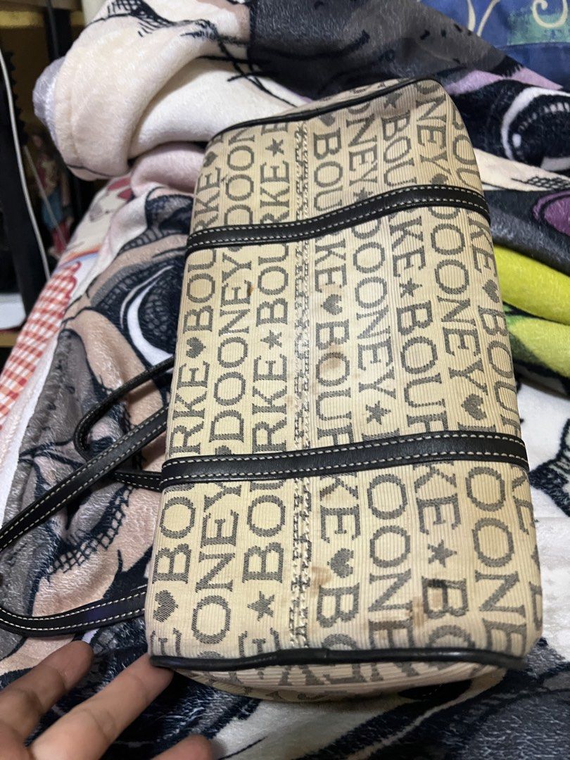 Dooney & Bourke Monogram Canvas Shoulder Bag (Category: Luxury Bags & Wallets) located in Quezon City. Submitted by cprmob (Listing ID 1453850044, Image 3). Description: - Classic Dooney & Bourke shoulder bag - Beige canvas with all-over logo print - Black leather trim and handles - Zipper closure - Interior: 1 zippered pocket, slip pockets - Ideal for everyday use.