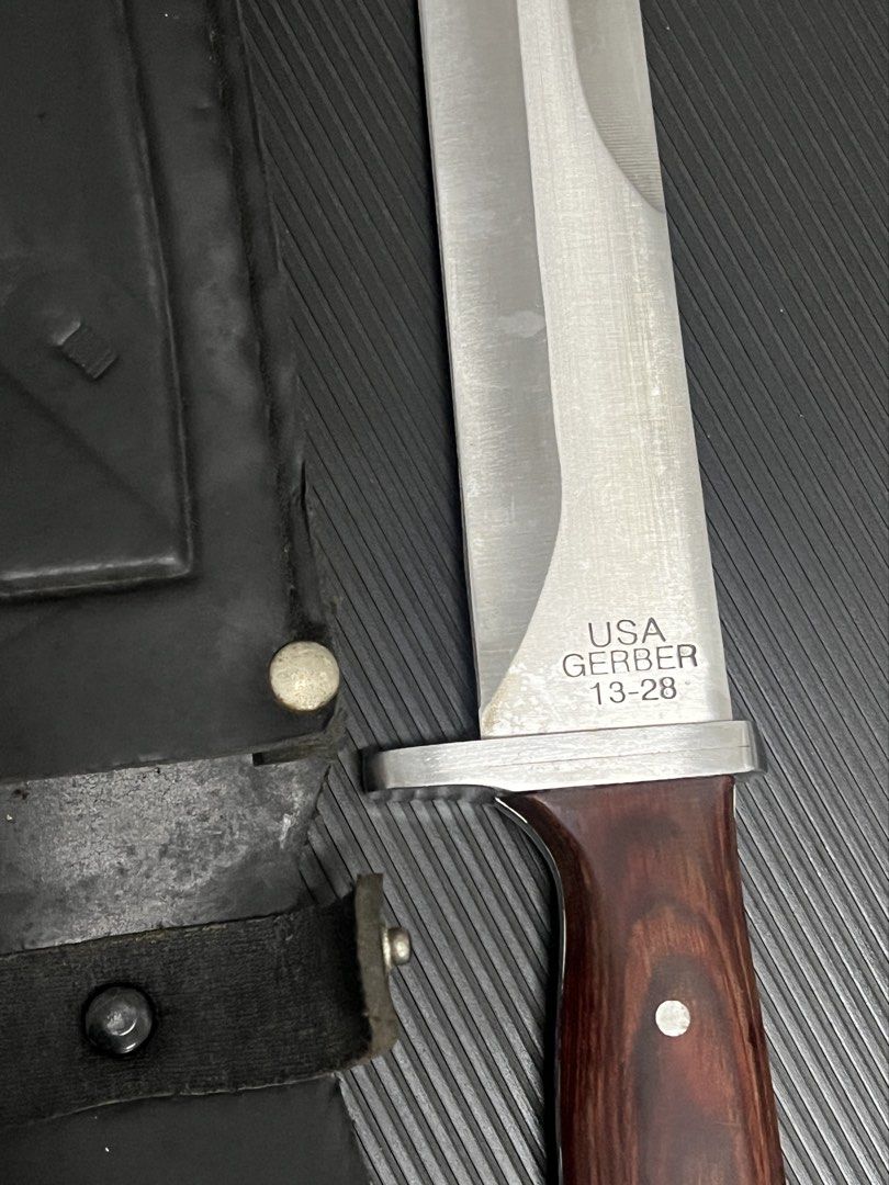 Gerber 13-28 USA Fixed Blade Knife with Sheath (Category: Hiking & Camping) located in Cebu City. Submitted by zershrovv (Listing ID 1453913738, Image 1). Description: - Gerber Fixed Blade Knife - Model: 13-28 - Made in USA - Features a durable wood handle - Sharp, reliable blade - Includes a leather sheath with belt loop - Ideal for outdoor use or as a collector's item.