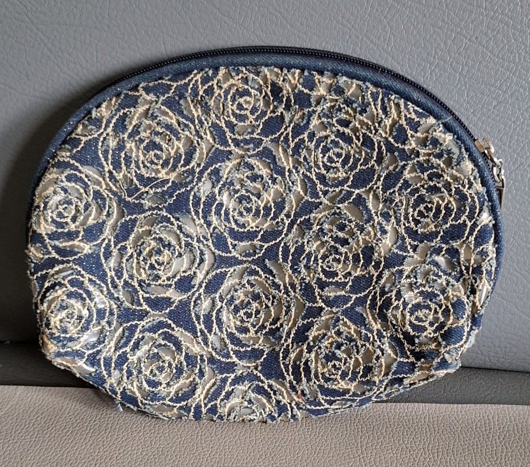 Givenchy Cosmetic Bag Blue Floral Lace (Category: Luxury Bags & Wallets) located in Don Carlos. Submitted by PphiXi_Finds (Listing ID 1453986417, Image 2). Description: - Cute Givenchy makeup pouch - Blue denim base with floral lace overlay - Zipper closure with branded pull tab - Lined interior - Ideal for organizing makeup and essentials - Approximately 7 inches wide.
