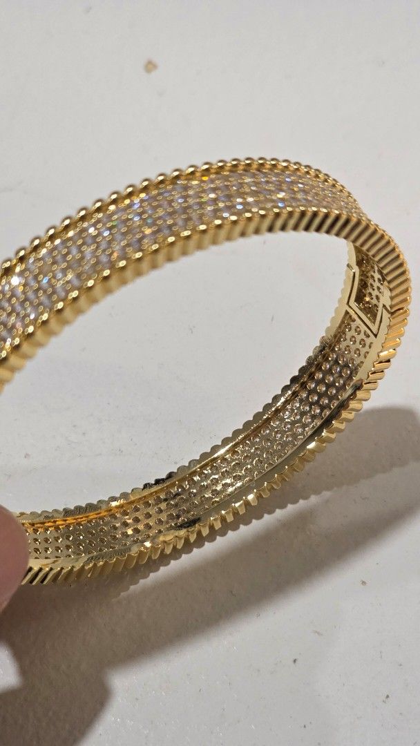Gold Bangle with Crystals (Category: Bracelets) located in Iloilo. Submitted by stellas21 (Listing ID 1453882287, Image 3). Description: - Sparkly gold bangle - Adorned with small, clear crystals - Features a ribbed texture on the sides - Secure clasp closure plated elegant bangles - Versatile for dressing up or everyday wear - Eye-catching and stylish accessory.
