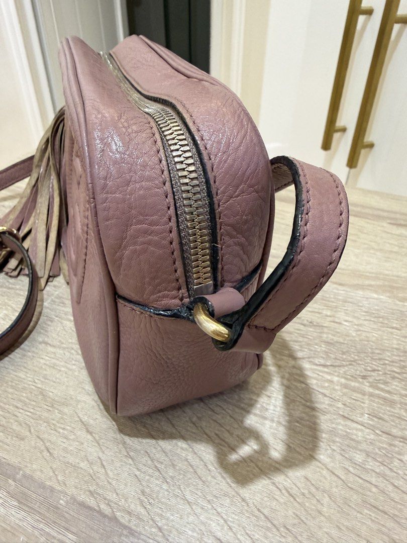 Gucci Soho Disco Bag Dusty Pink Leather (Category: Luxury Bags & Wallets) located in Quezon City. Submitted by minadigi8 (Listing ID 1453894337, Image 3). Description: - Dusty pink Gucci Soho Disco bag - Textured leather with embossed interlocking G logo - Tassel zipper pull - Crossbody strap - Gold-tone hardware - Signs of wear on leather and hardware, particularly strap attachments - Tassel shows some wear - Great for everyday use.