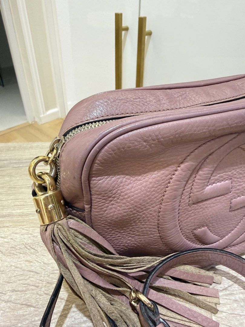 Gucci Soho Disco Bag Dusty Pink Leather (Category: Luxury Bags & Wallets) located in Quezon City. Submitted by minadigi8 (Listing ID 1453894337, Image 2). Description: - Dusty pink Gucci Soho Disco bag - Textured leather with embossed interlocking G logo - Tassel zipper pull - Crossbody strap - Gold-tone hardware - Signs of wear on leather and hardware, particularly strap attachments - Tassel shows some wear - Great for everyday use.