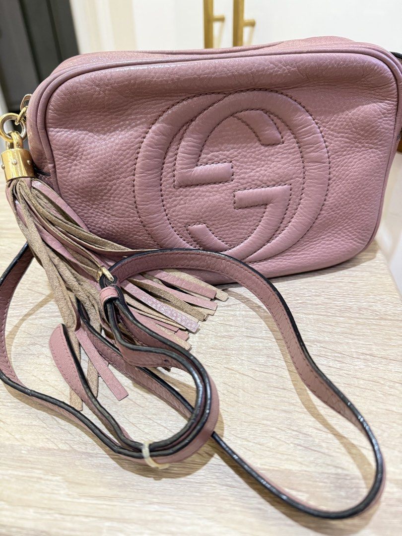 Gucci Soho Disco Bag Dusty Pink Leather (Category: Luxury Bags & Wallets) located in Quezon City. Submitted by minadigi8 (Listing ID 1453894337, Image 1). Description: - Dusty pink Gucci Soho Disco bag - Textured leather with embossed interlocking G logo - Tassel zipper pull - Crossbody strap - Gold-tone hardware - Signs of wear on leather and hardware, particularly strap attachments - Tassel shows some wear - Great for everyday use.