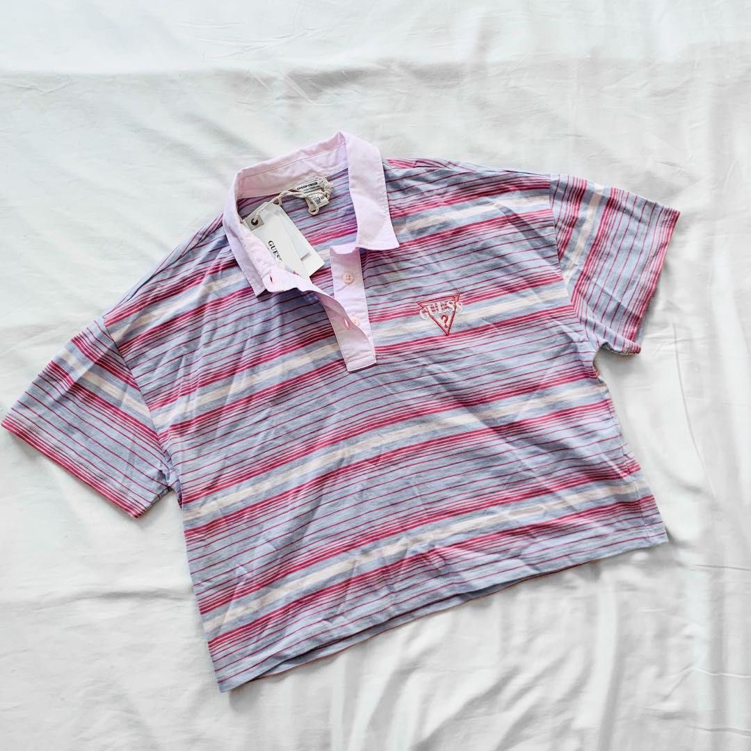 Guess Striped Cropped Polo Shirt (Category: Blouses) located in Cainta. Submitted by erraticgal (Listing ID 1453908571, Image 3). Description: - Cute Guess polo shirt - Cropped fit - Classic collar - Pastel blue, pink, and white stripes - Small embroidered Guess logo on chest - Great for a casual, retro vibe - Pairs well with high-waisted jeans Size is medium, original price is around 2000.