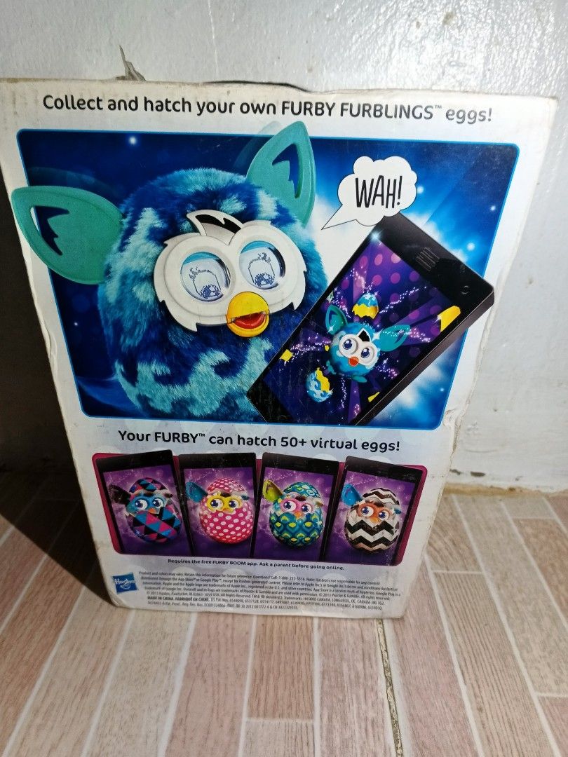 Hasbro Furby Boom! Interactive Toy - Blue (Category: Interactive Toys) located in Manila. Submitted by pogoniyar (Listing ID 1453921825, Image 3). Description: - Interactive Furby Boom toy in blue - Requires 4 AA batteries (not included) - Broken Poster and no sticker - has unknown leak (not battery leak since we check it and the battery compartment is empty) Need repair I don't know if battery ang problem or yung mismong toy na but pa check n'yo