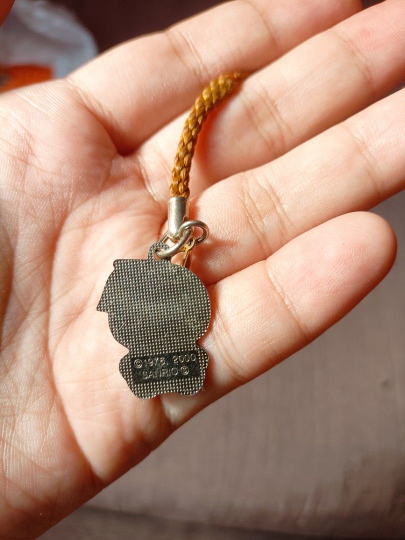 Hello Kitty Orange Charm with Strap - Sanrio 2000 (Category: Character Goods) located in Taal. Submitted by zildreiven (Listing ID 1453944172, Image 2). Description: - Adorable Kitty charm dressed as a cute orange. - Features a convenient strap, perfect for attaching to phones or bags. - Authentic Sanrio item, marked 2000. - Small and highly collectible. - A must-have for any Kitty enthusiast!.