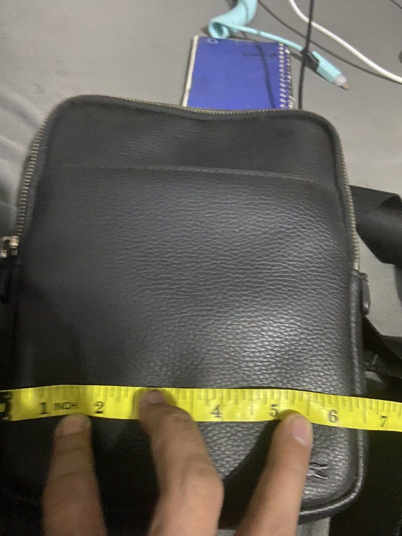 Lacoste Black Leather Crossbody Bag (Category: Sling Bags) located in Manila. Submitted by kdan29 (Listing ID 1444941901, Image 2). Description: - Authentic Lacoste crossbody bag - Color: Black - Material: Textured leather - Closure: Top zipper - Exterior: Front zipper pocket - Strap: Adjustable - Detail: Small Lacoste logo on front.