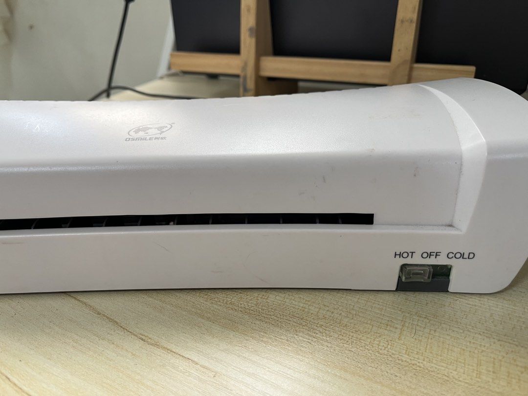 Laminating Machine (Category: Printers, Scanners & Copiers) located in Taguig. Submitted by decluttering_lola (Listing ID 1453850499, Image 2). Description: - A4 Size Laminator - Works with both Hot and Cold settings - Ideal for documents, photos, and crafts - Features an easy-to-use switch for Hot/Off/Cold - Tested and confirmed working - Minor scuffs on the casing due to storage.