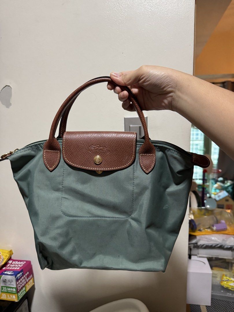 Longchamp Le Pliage Original S Hangbag (Category: Luxury Bags & Wallets) located in Quezon City. Submitted by ilovetoshop1234 (Listing ID 1453875233, Image 3). Description: - Classic Longchamp bag - Small size, perfect for essentials - Durable nylon with leather trim - Zipper closure with snap button flap - Comfortable top handles - Folds flat for easy storage - Versatile for any occasion Looks new from the outside. Has stains inside. .