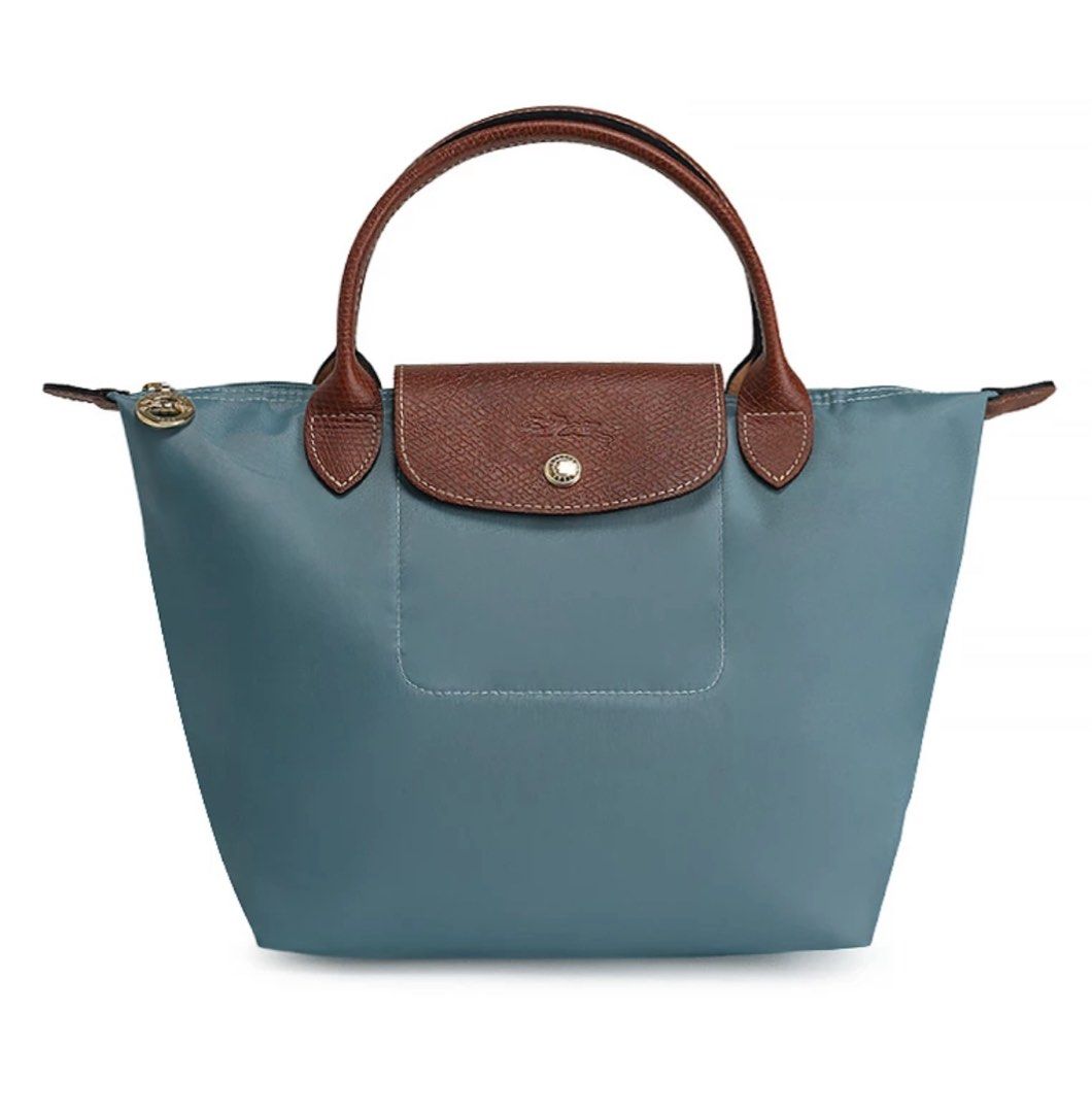 Longchamp Le Pliage Original S Hangbag (Category: Luxury Bags & Wallets) located in Quezon City. Submitted by ilovetoshop1234 (Listing ID 1453875233, Image 2). Description: - Classic Longchamp bag - Small size, perfect for essentials - Durable nylon with leather trim - Zipper closure with snap button flap - Comfortable top handles - Folds flat for easy storage - Versatile for any occasion Looks new from the outside. Has stains inside. .