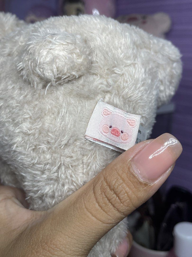 Lulu the Piggy teddy Plush (Category: Plushies & Soft Toys) located in Bulacan. Submitted by yanniee21 (Listing ID 1453878183, Image 3). Description: - Adorable lulu piggy plush toy - Unique design: Pig wearing a bear costume - Features a plaid ribbon with a gold charm - Made with soft and fluffy material .
