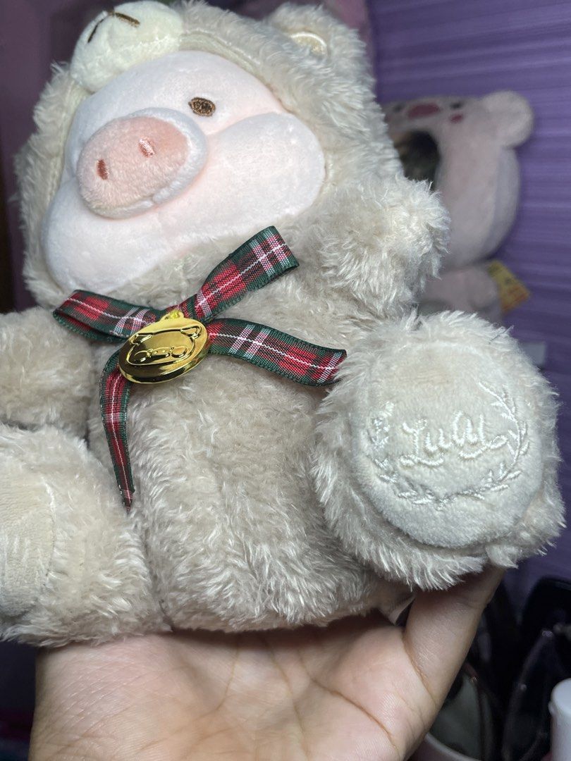 Lulu the Piggy teddy Plush (Category: Plushies & Soft Toys) located in Bulacan. Submitted by yanniee21 (Listing ID 1453878183, Image 2). Description: - Adorable lulu piggy plush toy - Unique design: Pig wearing a bear costume - Features a plaid ribbon with a gold charm - Made with soft and fluffy material .