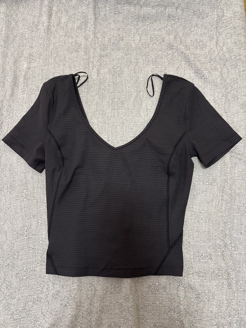 Lululemon Black Short Sleeve Top Size 2 (Category: Activewear) located in Mandaluyong City. Submitted by xxtin (Listing ID 1453870008, Image 1). Description: - Lululemon cropped top in black - Textured honeycomb pattern all over - Deep V-neckline - Flattering, body-contouring seams - Lululemon logo detail on the front - Made in Vietnam - Fabric: 80% Nylon, 20% Elastane.