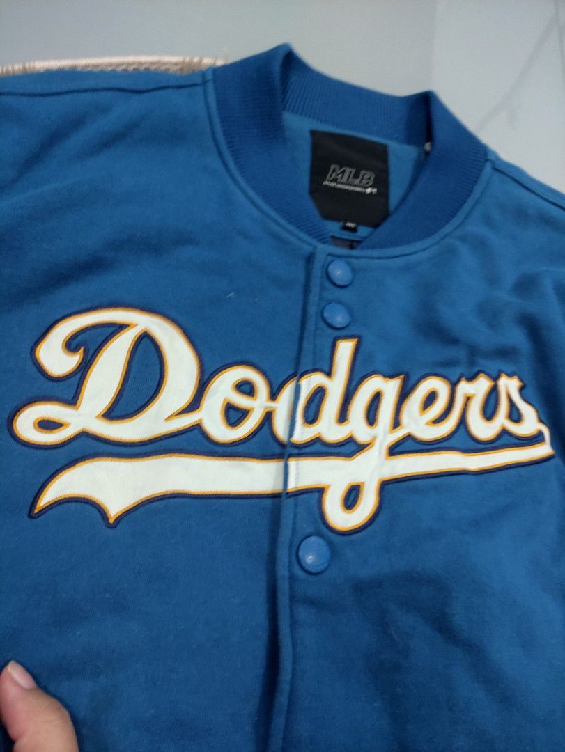 MLB Los Angeles Dodgers Varsity Jacket (Category: Coats, Jackets and Outerwear) located in Manila. Submitted by shellys_collection (Listing ID 1453865079, Image 2). Description: - Classic blue and grey varsity jacket - Features iconic Dodgers and LA logos - Button-up front for easy wear - Ribbed cuffs and hem for a snug fit - Authentic MLB branded tag inside - A must-have for any Los Angeles Dodgers fan!.