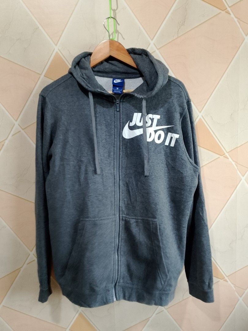 Nike Just Do It Grey Zip-Up Hoodie (Category: Hoodies) located in San Pedro. Submitted by jokwanrocks09 (Listing ID 1453999697, Image 1). Description: Grey Nike hoodie with the "Just Do It" graphic on the front. Full zip closure and front pockets. Made from a cotton and polyester blend. Tagged as size L. Great for everyday wear. 22x27 large to XL slight scratch on the sleeve .
