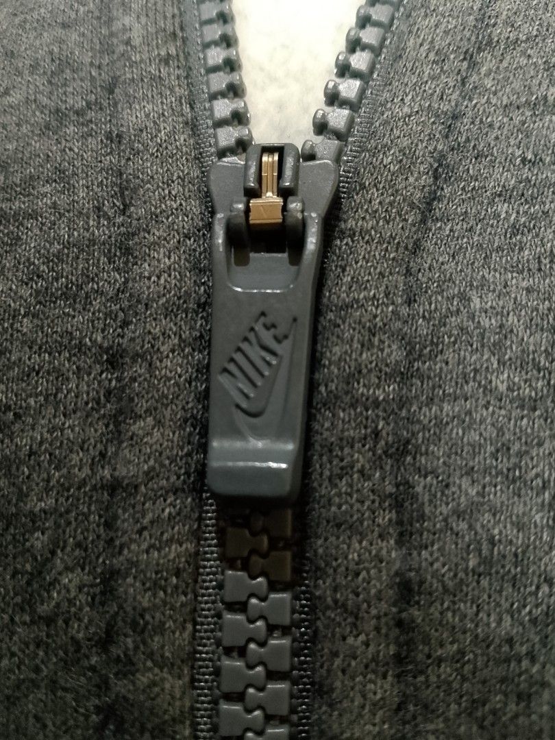 Nike Just Do It Grey Zip-Up Hoodie (Category: Hoodies) located in San Pedro. Submitted by jokwanrocks09 (Listing ID 1453999697, Image 3). Description: Grey Nike hoodie with the "Just Do It" graphic on the front. Full zip closure and front pockets. Made from a cotton and polyester blend. Tagged as size L. Great for everyday wear. 22x27 large to XL slight scratch on the sleeve .