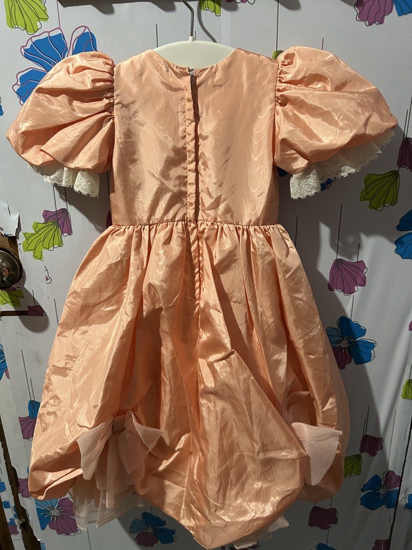 Peach Puff Sleeve Dress with Bows (Category: Babies & Kids Fashion) located in San Jose. Submitted by coolbear-85a9de (Listing ID 1453964713, Image 3). Description: - Cute peach dress for little girls - Puffy short sleeves with delicate lace trim - Bubble hem skirt with two charming front bows - Convenient back zipper closure - Ideal for parties and special events.