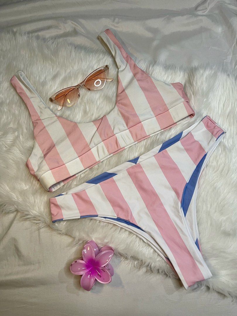 Pink & White Striped 2 Piece Bikini Set with Blue Reversible Bottom (Category: Bikinis & Swimsuits) located in Manila. Submitted by sugarplumthreadsph (Listing ID 1453985089, Image 3). Description: - Size: Medium - Cute striped bikini set - Scoop neck top - High-waisted bottoms with blue stripes on one side - Includes matching sunglasses - Comes with a flower hair clip - Ideal for beach or pool days - Clean and ready to wear .