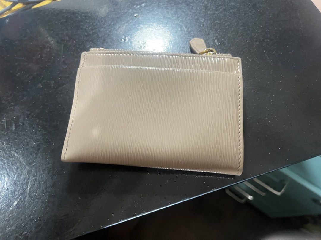 Prada Beige Saffiano Leather Card Holder Wallet (Category: Luxury Bags & Wallets) located in Pasay City. Submitted by msthriftshopp (Listing ID 1453955791, Image 3). Description: - Authentic Prada card holder - Beige saffiano leather - Multiple card slots - Zip compartment - Gold hardware - Small and compact design - Ideal for everyday use.