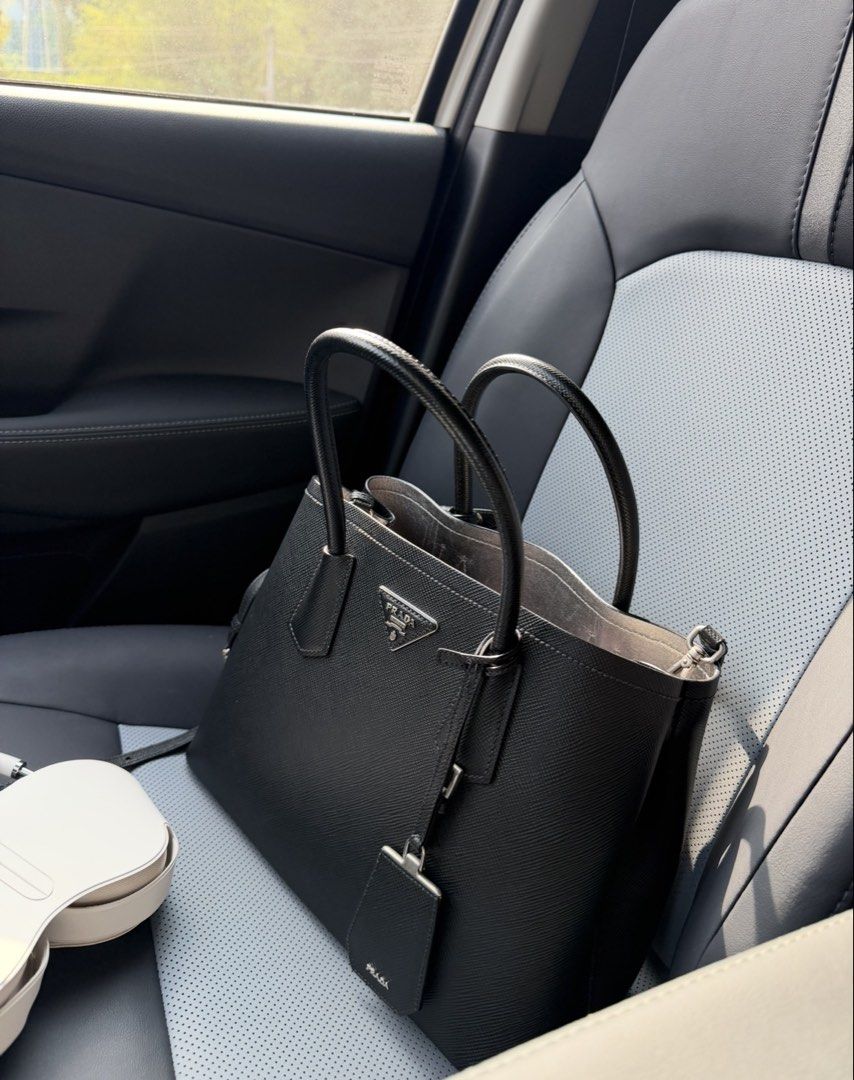 AUTHENTITICPrada Saffiano Leather Tote Bag (Category: Luxury Bags & Wallets) located in Cebu City. Submitted by gdcebu (Listing ID 1453894579, Image 1). Description: - Classic Prada tote bag - Material: Black Saffiano leather - Includes: Shoulder strap and dust bag - Interior: Clean - Exterior: Minimal signs of wear - Style: Timeless, perfect for everyday use.
