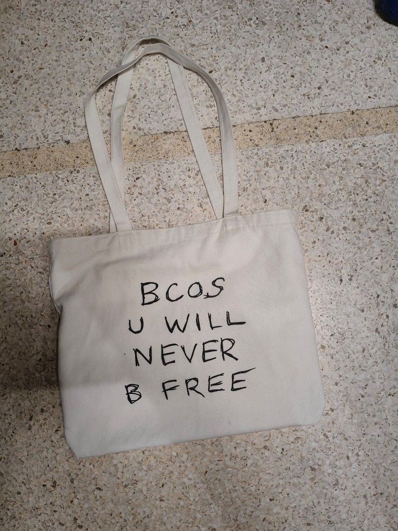 Rex Orange County Tote Bag Merch Original with exclusive ROC guitar pick (Category: Tote Bags) located in Taguig. Submitted by decluttermm (Listing ID 1453927033, Image 2). Description: - Official Rex Orange County Live 2023 Tour merchandise - Features a cool black cat graphic on one side - Includes the iconic lyrics 'BCOS U WILL NEVER B FREE' on the other side - Made from durable canvas material - Ideal for everyday use, carrying essentials, or 