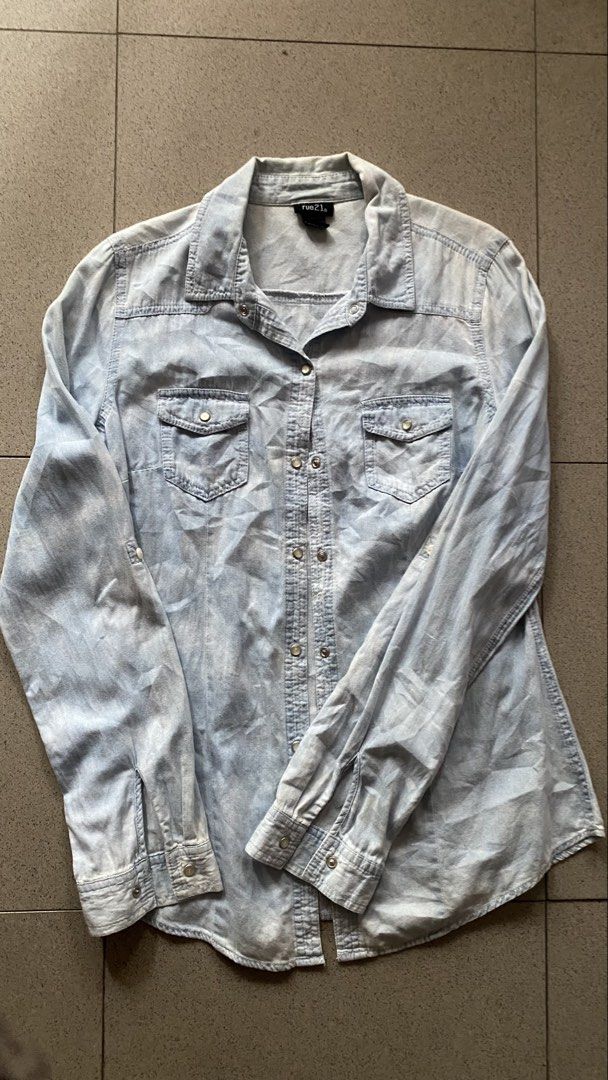 rue21 Soft Light Wash Denim Snap Button Shirt (Category: Coats, Jackets and Outerwear) located in Cavite. Submitted by bocchi64 (Listing ID 1453815715, Image 1). Description: Brand: rue21 Size Tag: Small (S) Fit: Relaxed / Slightly Oversized (Fits Small to Medium comfortably) Color: Light Wash Denim / Light Blue Features: Pearl snap buttons, dual chest flap pockets, long sleeves Condition: Preloved, it has yellow stain but unrecognizable ( probab